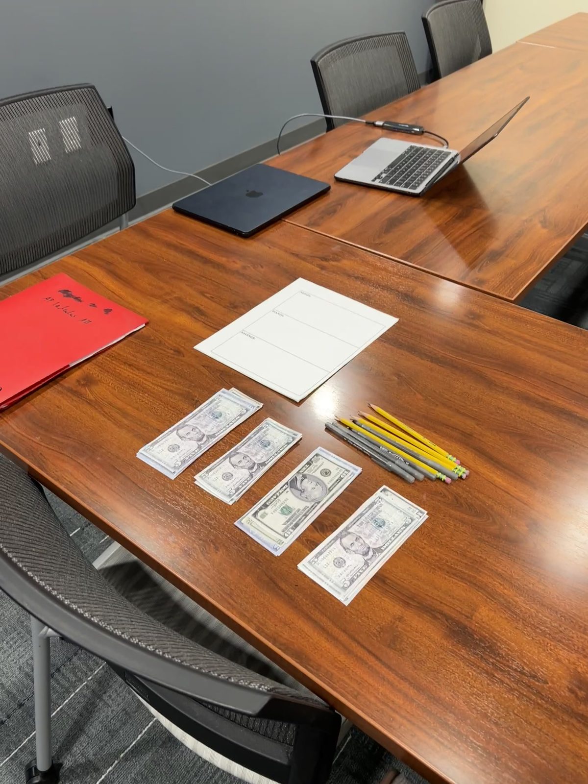 Play money, pencils, and worksheets set out for students at Berkeley Heights Library