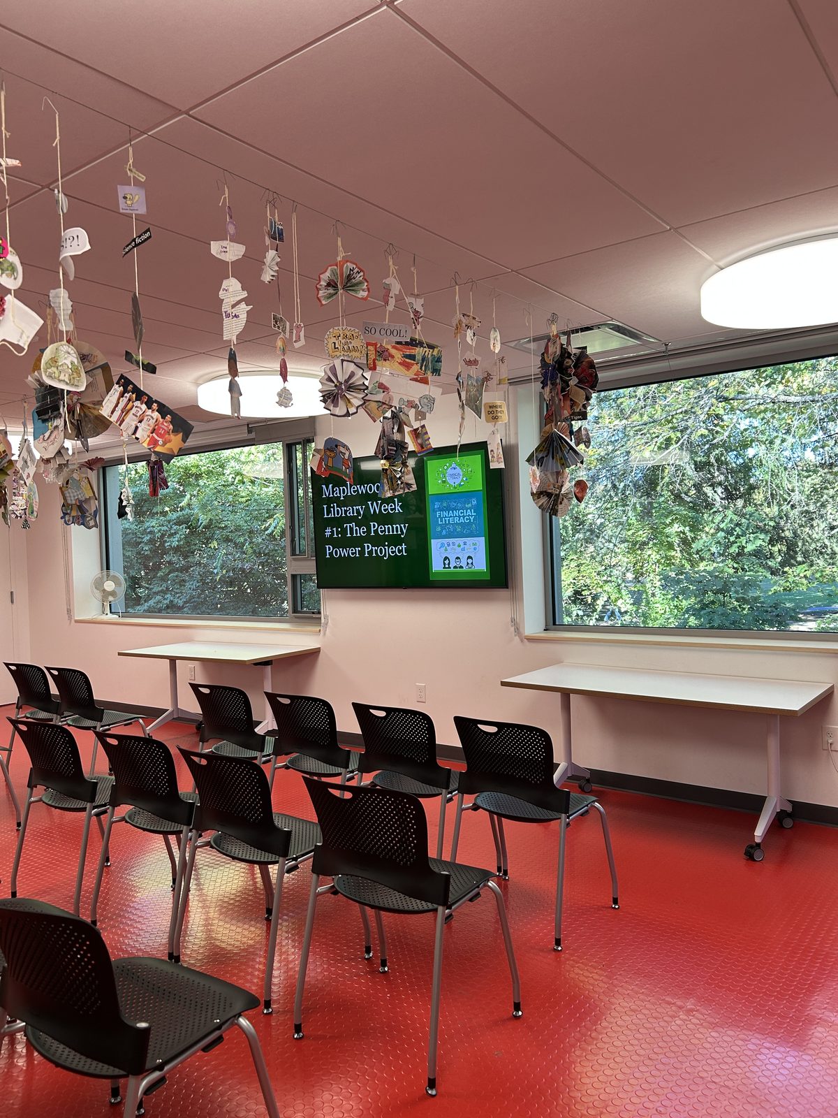 Maplewood Library program room set up with rows of chairs and a Penny Power Project slide on the screen