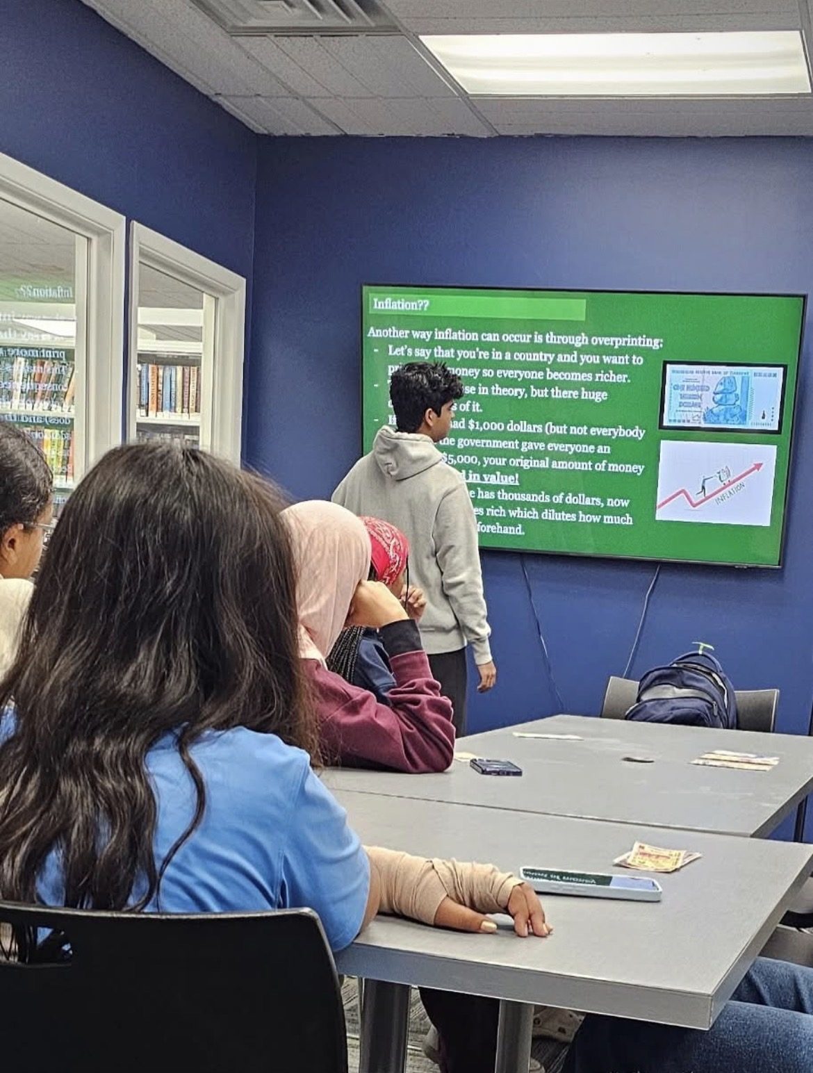 Students following a lesson on inflation at Roseland Free Public Library